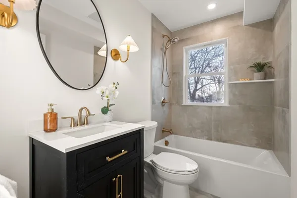 a bathroom with a sink a toilet and a mirror