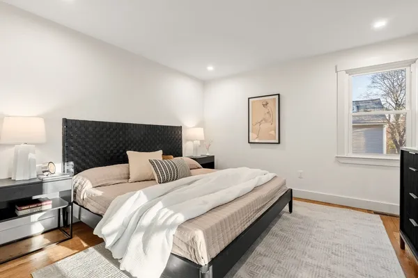 a bedroom with bed and a window