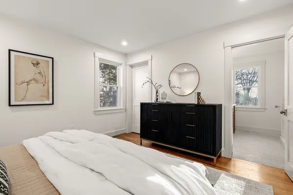 a bedroom with a large bed and a dresser