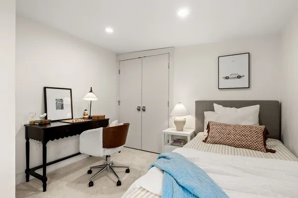 a bedroom with a bed a desk and chair