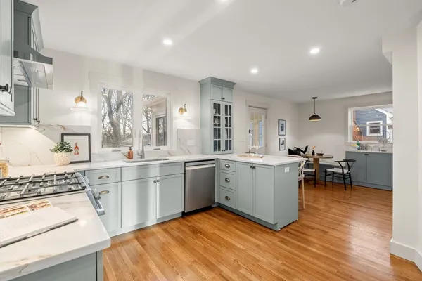 a kitchen with a sink and chairs