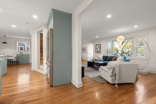 a living room with furniture and a wooden floor
