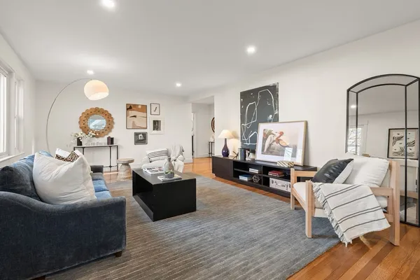 a living room with furniture and wooden floor
