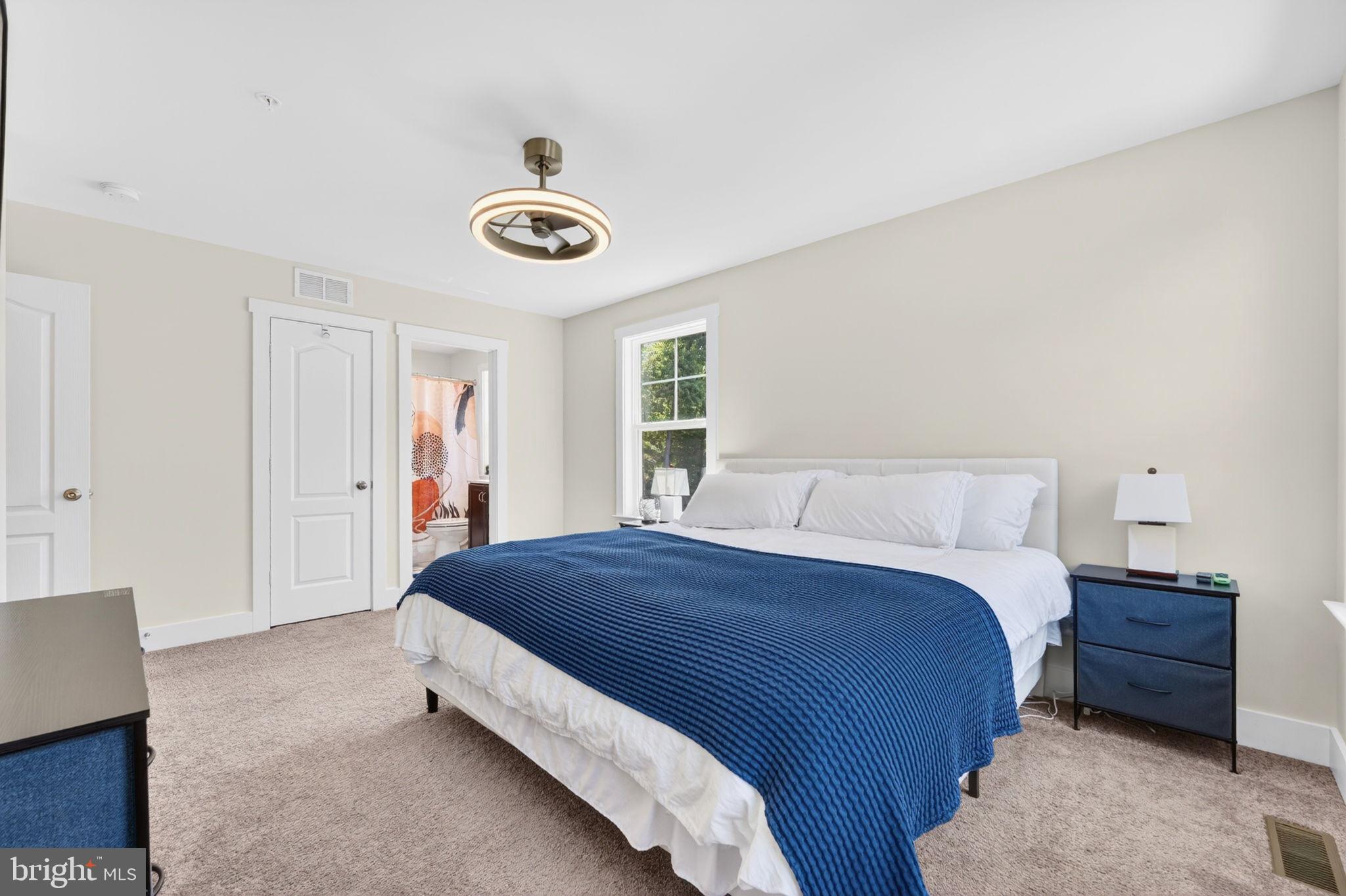 30 Range Road North East, MD 21901 - Photo 54 of 73 a spacious bedroom with a bed and a window