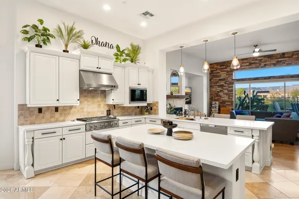 a kitchen with stainless steel appliances a refrigerator and a stove top oven