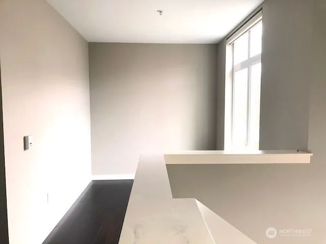 a view of a living room with wooden floor