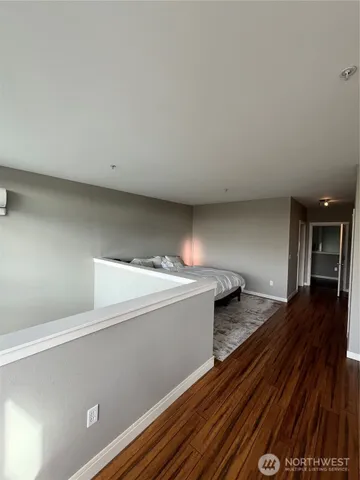 a view of hallway with wooden floor