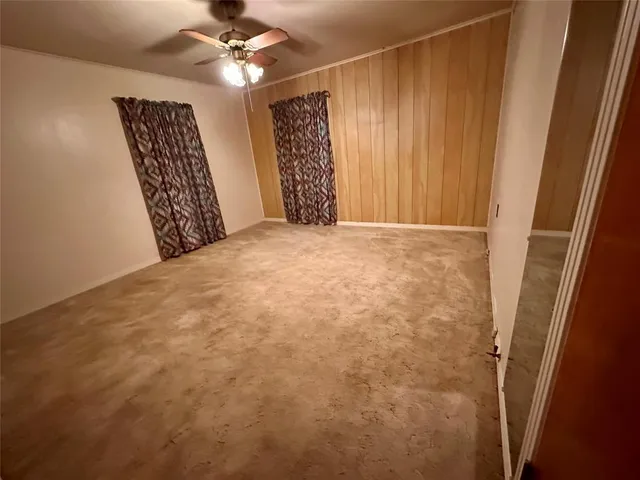 a view of a livingroom with a ceiling fan and window