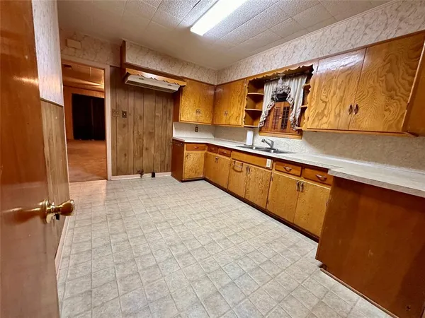 a room with a sink and cabinets