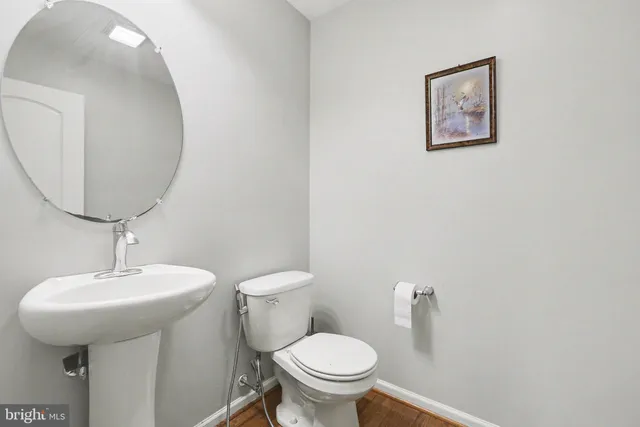 a bathroom with a toilet a sink and a mirror