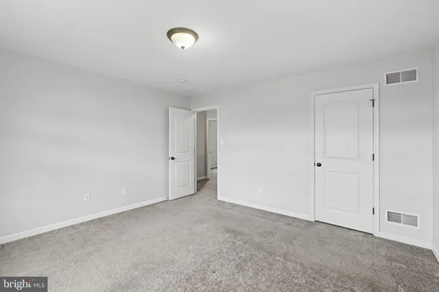 a view of an empty room and closet area
