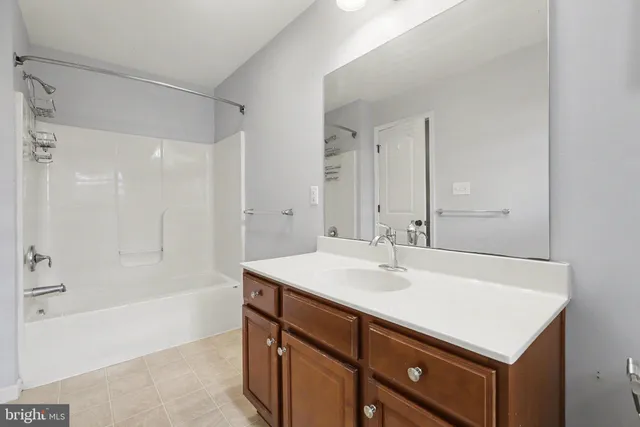 a bathroom with a sink a shower and a mirror