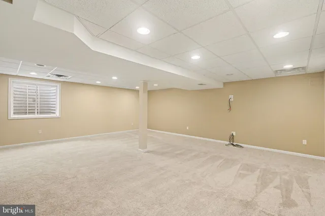 an empty room with a empty space and windows