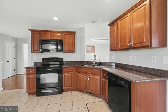 a kitchen with a stove a sink and a microwave