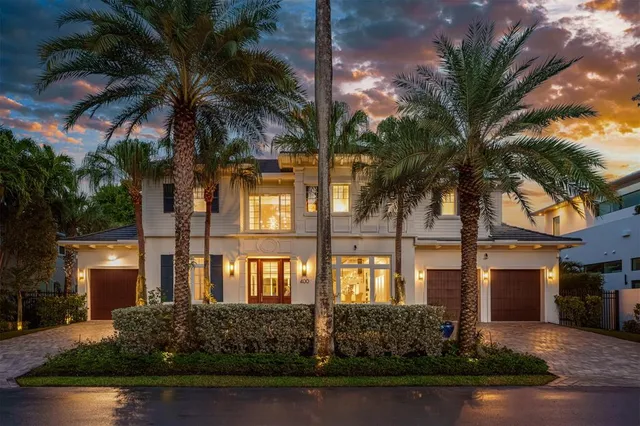 a front view of a house with yard and green space