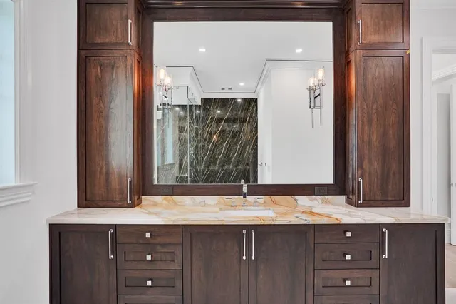 a bathroom with a granite countertop toilet sink and shower