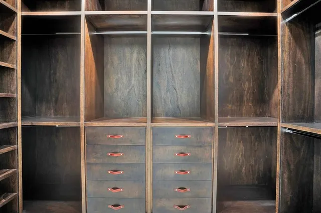 a view of walk in closet with empty racks