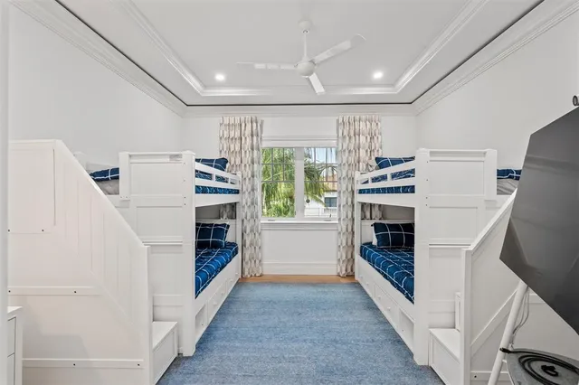 a swimming pool with potted plants and large tree