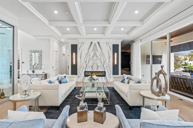 a kitchen with stainless steel appliances a white table chairs and a refrigerator