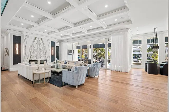a large kitchen with kitchen island a white counter space a sink stainless steel appliances and cabinets