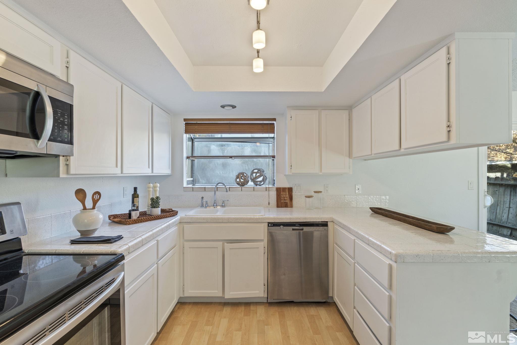 1960 Peavine Road Reno, NV 89503 - Photo 8 of 32 a kitchen with stainless steel appliances a sink stove and cabinets