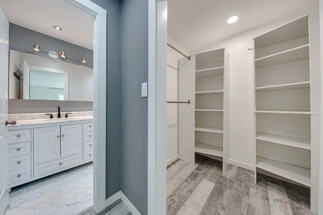 a spacious bathroom with a double vanity sink and a mirror