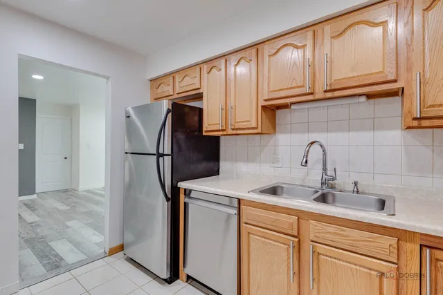 a kitchen with stainless steel appliances granite countertop a refrigerator sink and cabinets