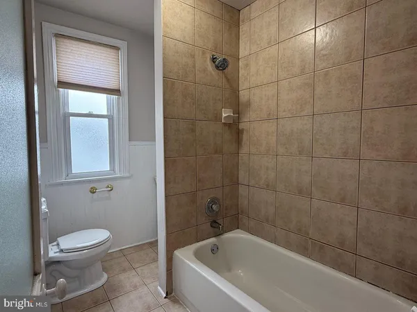 a bathroom with a toilet and bathtub