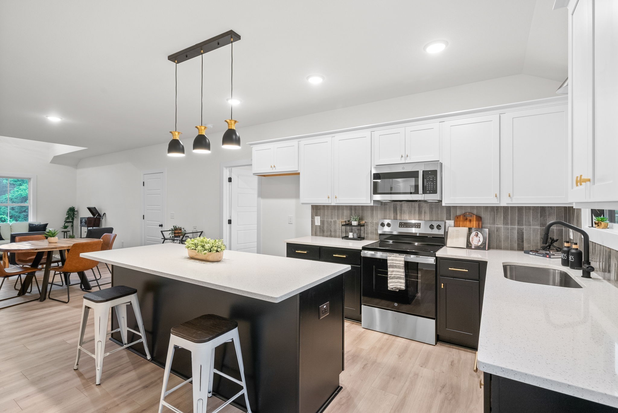 201 Dewberry Road Clarksville, TN 37042 - Photo 16 of 56 a kitchen with stainless steel appliances a sink a stove a table and chairs