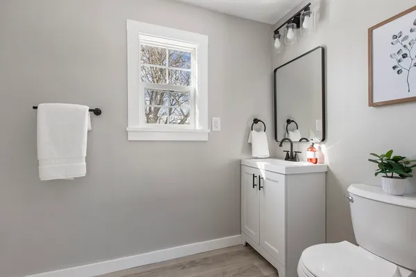 a bathroom with a toilet sink and mirror