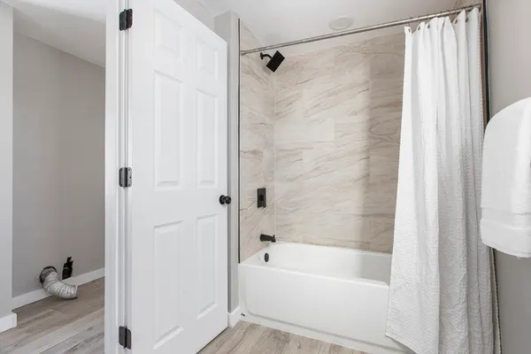 a bathroom with a bathtub and a shower
