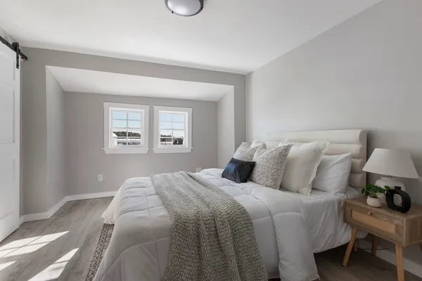 a bedroom with bed and a window