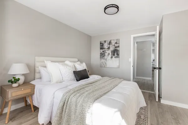 a bedroom with a bed and a lamp