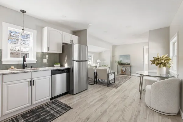 a kitchen with refrigerator and cabinets