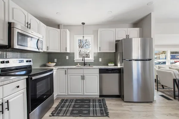 a kitchen with a refrigerator stove and sink
