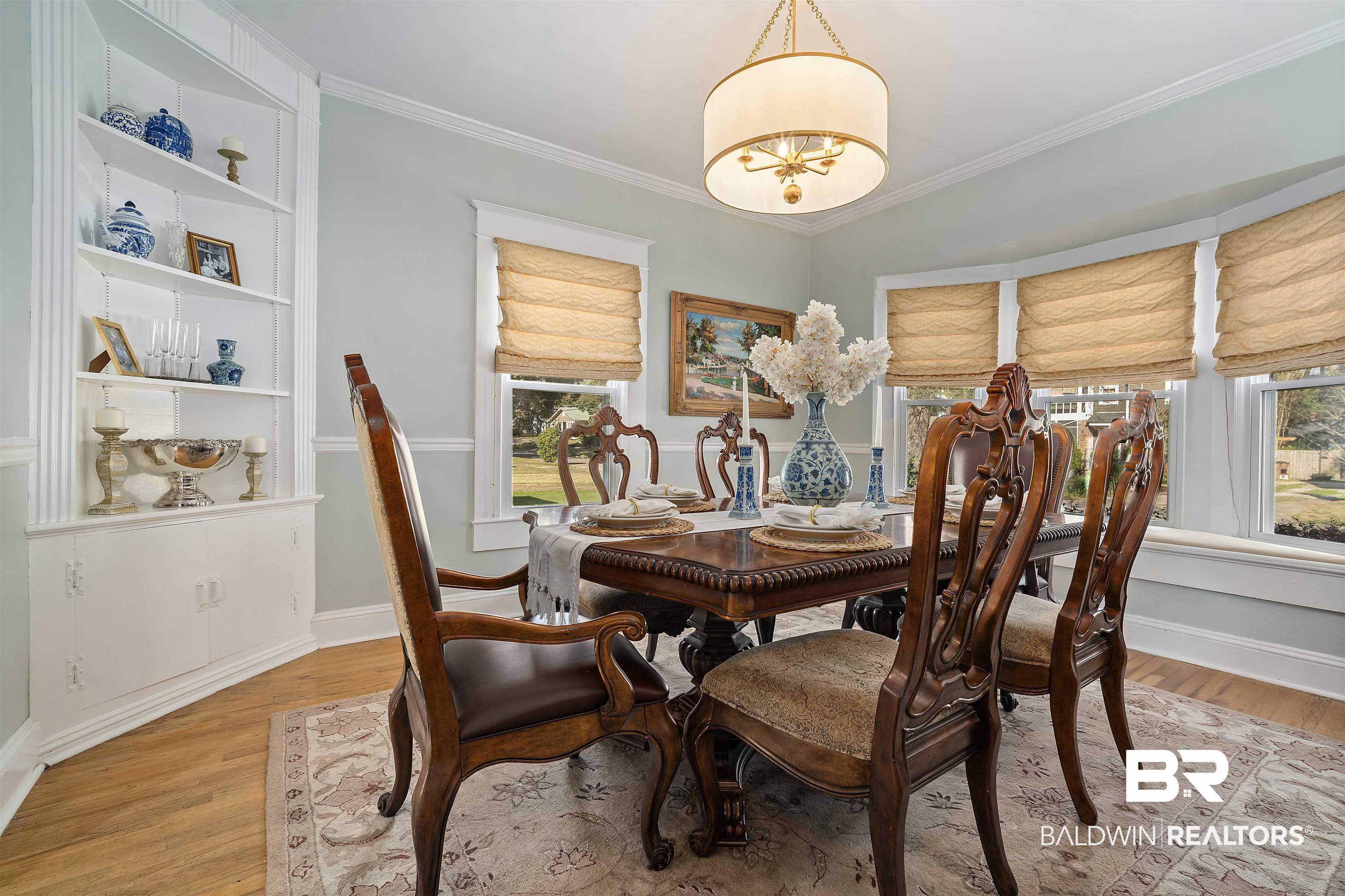 168 Mohawk Street Mobile, AL 36606 - Photo 13 of 31 Dining area featuring light wood-style flooring, suspended lighting, ornamental molding, and healthy amount of natural light