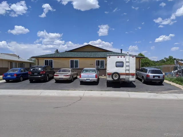 a view of cars parked in front of a building