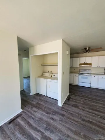 a view of a kitchen with wooden floor