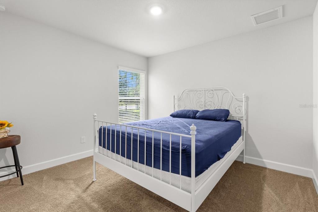 11042 Heth Court Weeki Wachee, FL 34613 - Photo 19 of 43 a bed sitting in a bedroom next to a window