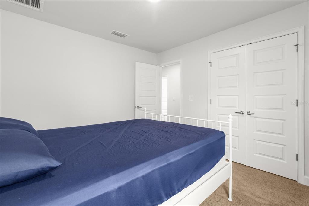 11042 Heth Court Weeki Wachee, FL 34613 - Photo 20 of 43 a bedroom with a bed and cabinet