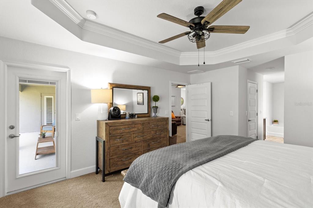 11042 Heth Court Weeki Wachee, FL 34613 - Photo 27 of 43 a bedroom with a bed and a chandelier