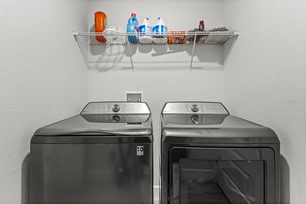 11042 Heth Court Weeki Wachee, FL 34613 - Photo 32 of 43 a utility room with dryer and washer