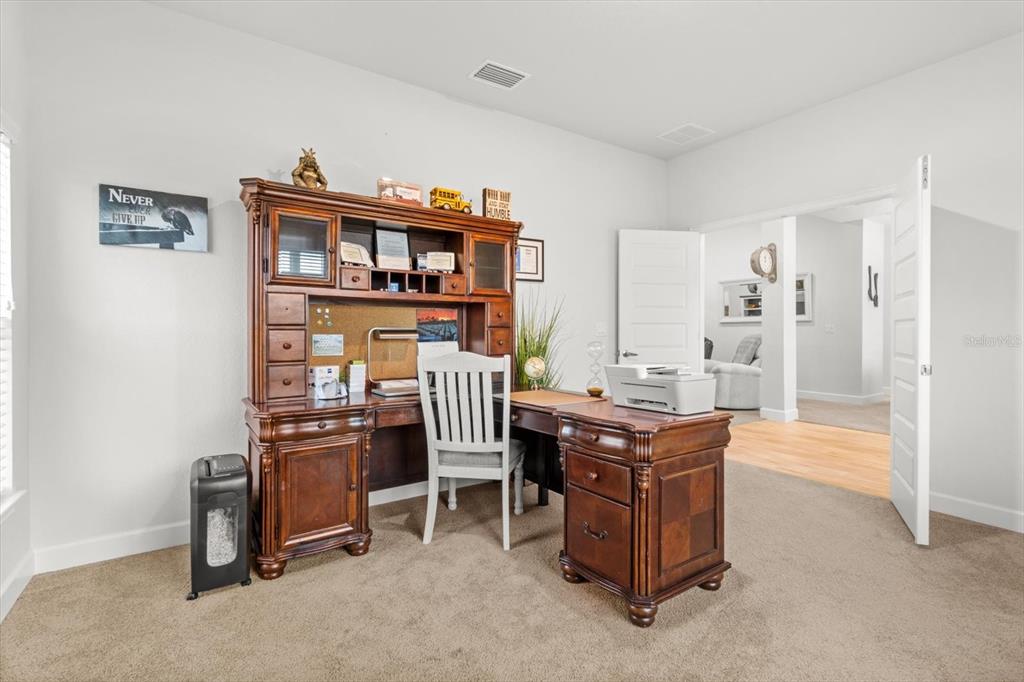 11042 Heth Court Weeki Wachee, FL 34613 - Photo 7 of 43 a room with furniture and a bookshelf