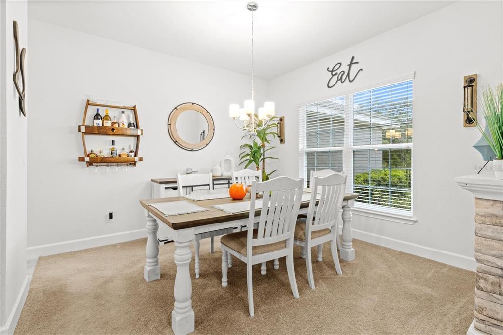 11042 Heth Court Weeki Wachee, FL 34613 - Photo 8 of 43 a view of a dining room with furniture window and wooden floor