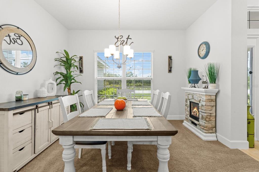 11042 Heth Court Weeki Wachee, FL 34613 - Photo 9 of 43 a view of a dining room with furniture a chandelier and wooden floor