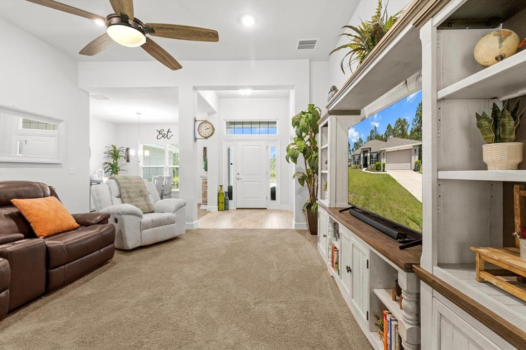 11042 Heth Court Weeki Wachee, FL 34613 - Photo 10 of 43 a living room with furniture and a flat screen tv