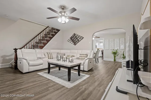 a living room with furniture and a wooden floor