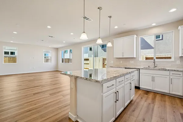 a kitchen with stainless steel appliances granite countertop a stove and a microwave