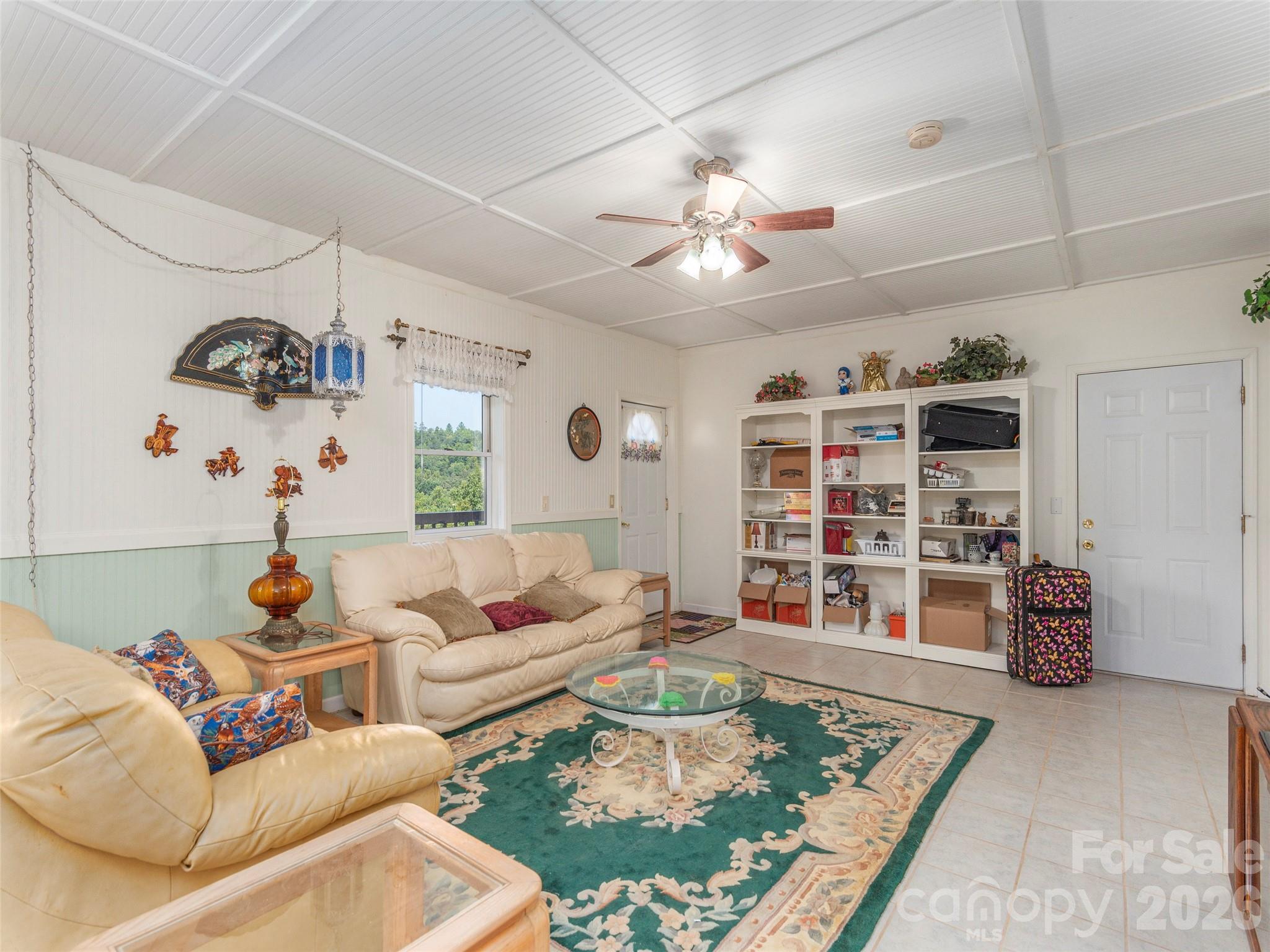 1120 Jacobs Branch Road Franklin, NC 28734 - Photo 22 of 36 a living room with furniture and a book shelf