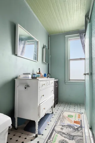 a kitchen with a stove a sink and a window